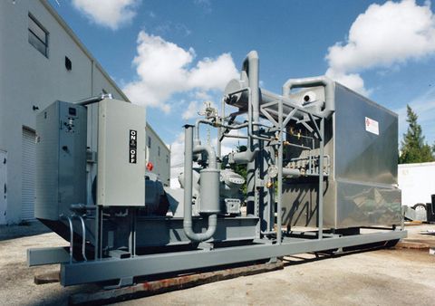 A skid-mounted industrial refrigeration unit with compressor, piping and control panel